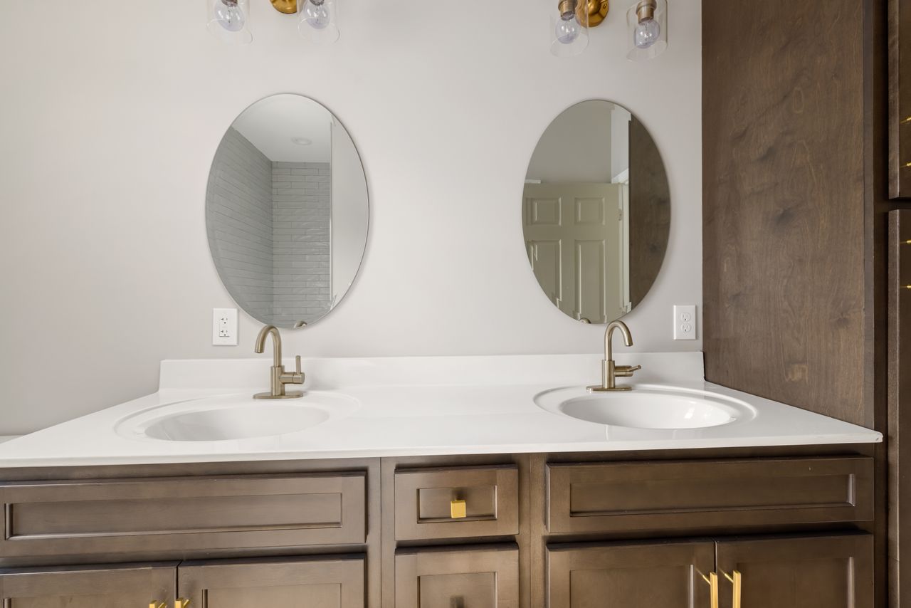Crafting Captivating Headlines: Your awesome post title goes here Modern bathroom vanity featuring dual sinks with oval mirrors and stylish fixtures. Perfect for home decor inspiration.