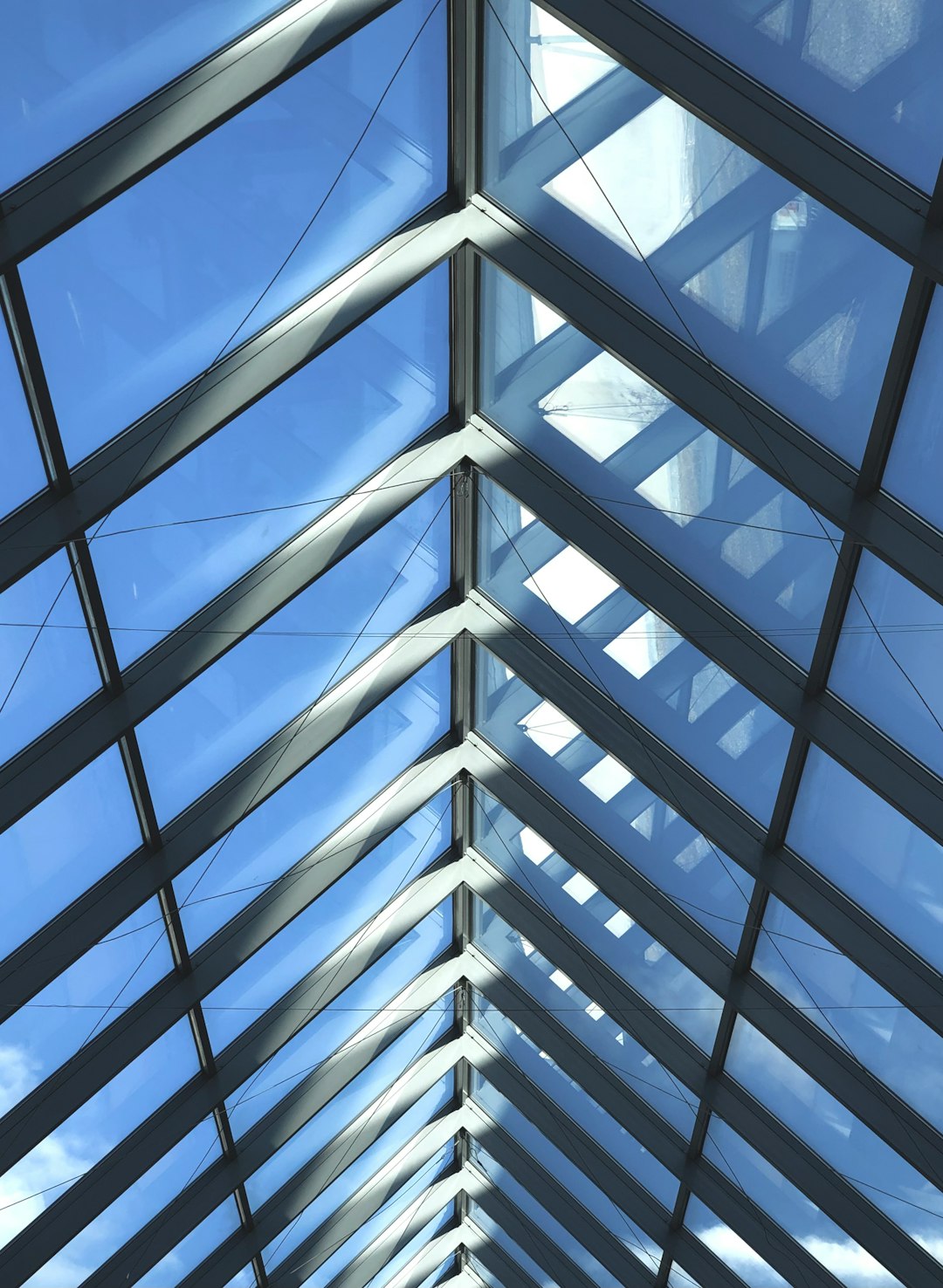 service-02 Angled glass roof of a building with sunlight shining through